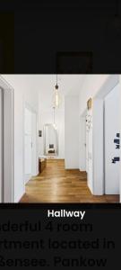 a white room with a hallway with two doors at Helenas place in Berlin