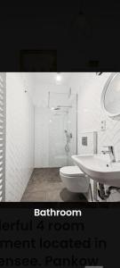a white bathroom with a sink and a toilet at Helenas place in Berlin