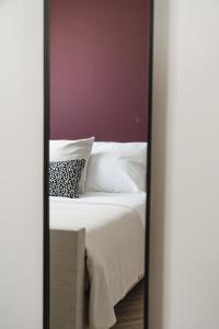 a bedroom with a white bed and a mirror at Shortstay - De Pastorie, Gouda in Gouda