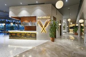 a restaurant lobby with a x sign on the wall at Titanic Deluxe Lara in Lara +37 photos