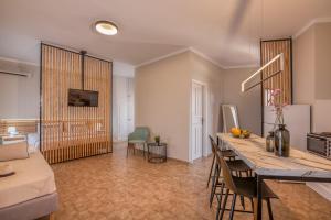 a kitchen and living room with a table and chairs at Georgia Vicky Studios & Apartments in Stavros