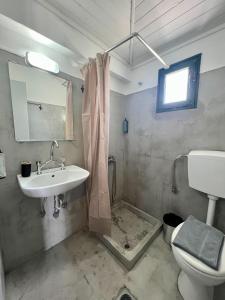 a bathroom with a sink and a toilet at Issos Studios in Agios Georgios