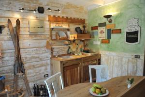 a kitchen with a table and a sink and a counter at Bonavia B&B in Sistiana