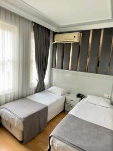 a bedroom with two beds and a window at Grand Hurriyet Hotel in Istanbul