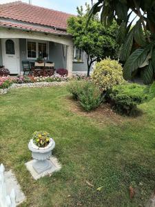 a house with a flower arrangement in a yard at The Little Blooming House in Agíasma