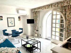 a living room with a blue couch and a table at Villa Le Palme in Ischia