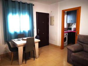 a living room with a table and chairs and a kitchen at Camposoto in San Fernando