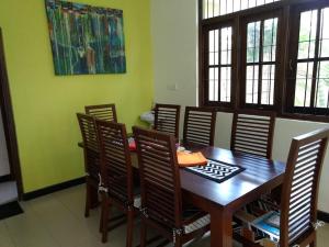 a dining room with a wooden table and chairs at A tropical paradise; stunning house, pool, garden in Wattala