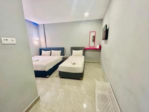Postel nebo postele na pokoji v ubytování Hotel Dlima Inn Bukit