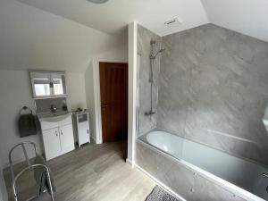 a large bathroom with a tub and a sink at Cosy apartment in Eccleshall in Eccleshall