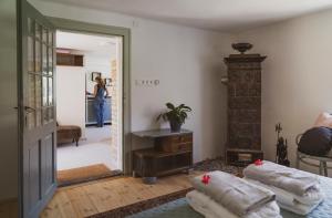 a woman is walking into a room with a mirror at Zamatos Turbolya Kisház és Wellness in Pannonhalma