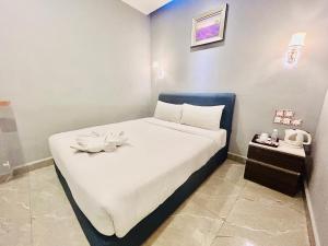 Postel nebo postele na pokoji v ubytování Hotel Dlima Inn Bukit