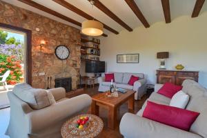 a living room with couches and a stone wall at Casa Renata in Jávea