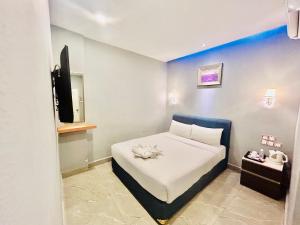 Postel nebo postele na pokoji v ubytování Hotel Dlima Inn Bukit