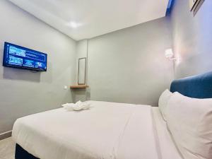 Postel nebo postele na pokoji v ubytování Hotel Dlima Inn Bukit