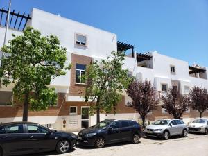 a group of cars parked in front of a building at Cabanas de Tavira Smashing 2 bed, 2 bath, Duplex Penthouse in Cabanas de Tavira