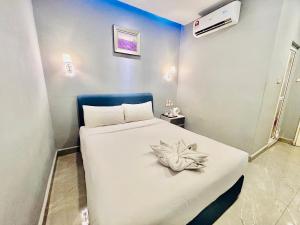 Postel nebo postele na pokoji v ubytování Hotel Dlima Inn Bukit