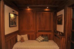a bed in a room with wood paneling at Bonavia B&B in Sistiana