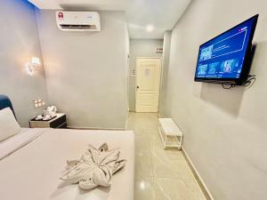 TV a/nebo společenská místnost v ubytování Hotel Dlima Inn Bukit