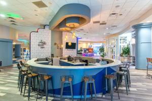 a bar in a restaurant with stools at 16th Floor 1 BR Resort Condo Direct Oceanfront Wyndham Ocean Walk Resort Daytona Beach 1605 in Daytona Beach