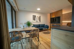 a living room with a table and chairs and a couch at Anders Apartments in Jena