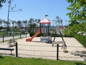 a playground in a park with a slide at Kampaoh Gala in Figueira da Foz