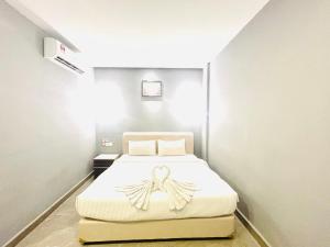 Postel nebo postele na pokoji v ubytování Hotel Dlima Inn Bukit
