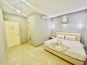 Postel nebo postele na pokoji v ubytování Hotel Dlima Inn Bukit