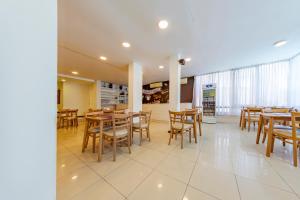 a dining room with wooden tables and chairs at Hotel Sialdorf in Villa Carlos Paz