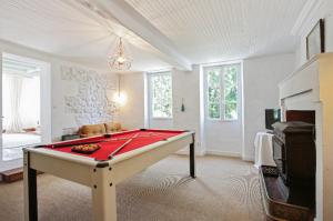 a living room with a pool table in it at Villa Mamba in Saint-Porchaire