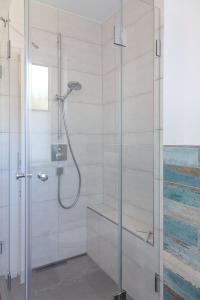 a shower with a glass door in a bathroom at Drr20 1 Walter in Westerland
