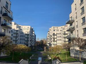 a view of two tall apartment buildings at Przytulny apartament z parkingiem in Łódź