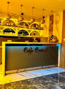 a kitchen with yellow walls and a shelf with food at Grand Hurriyet Hotel in Istanbul