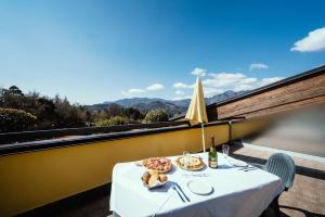 a table with a plate of food on a balcony at Hotel Residence Campi in Tremosine Sul Garda