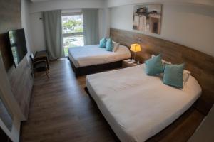 Cama ou camas em um quarto em Mod Hotels Mendoza