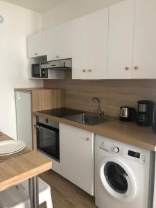 a kitchen with a washing machine and a sink at En hyper centre, Le Saint Aubin in Angers