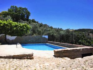 a swimming pool in a yard with a fence at Belvilla by OYO Casa Almendro in La Joya