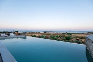 a swimming pool with a view of the desert at Cycladic Breeze Villas in Kampos Paros