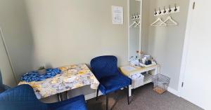 a room with a table and two chairs and a desk at Árból Guesthouse in Húsavík