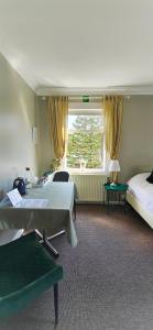 a hotel room with two beds and a window at Árból Guesthouse in Húsavík