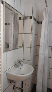 a bathroom with a sink and a mirror at Kleine Wohnung in Bad Schwartau in Bad Schwartau