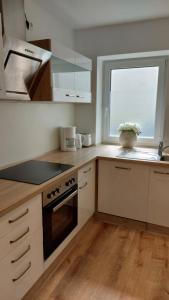 a kitchen with a stove and a window in it at Kleine Wohnung in Bad Schwartau in Bad Schwartau