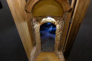 an archway in a house with a stone wall at Secret Jacuzzi Mons - Parking privé gratuit in Mons