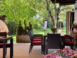 a patio with tables and chairs and a playground at Ameiserhof Guesthouse in Collalbo