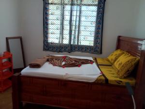Cama pequeña en habitación con ventana en Magharibi House, en Nungwi