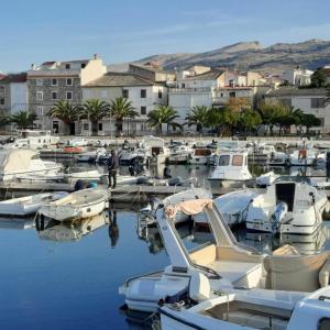a bunch of boats are docked in a harbor at Sugar house in Pag