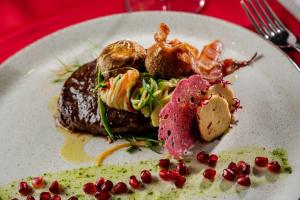 a plate of food on a red table at Hotel Cvita in Split