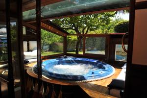 a hot tub sitting on a table in a house at Bonavia B&B in Sistiana