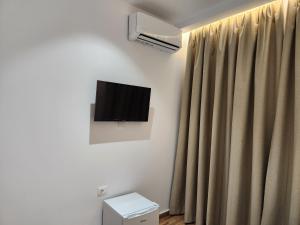a room with a curtain and a television on the wall at Sea Front Villa in Vlorë