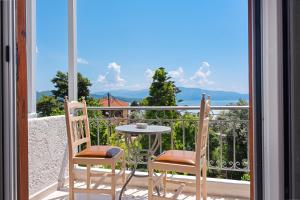 a balcony with a table and two chairs and a view at ALEXANDROS B in Nikiana